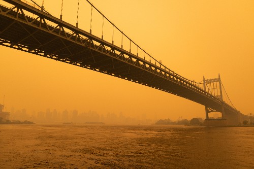 New York bridge covered in yellow smoke